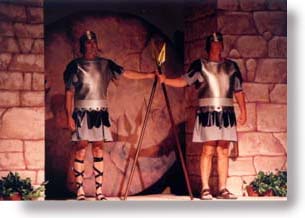 Two Roman soldiers guard the sealed tomb.