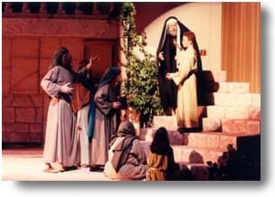 A young Jesus on a stairway, teaching in the temple.