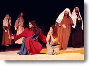 Jesus and the woman caught in adultery with religious leaders around them.