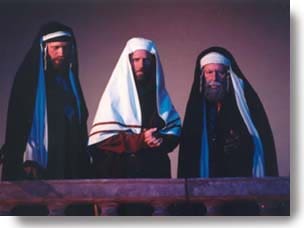 Three Pharisees looking down with judgement.