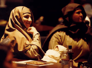 A woman, dressed in Bible costume, resting during a rehearsal for this dramatic Easter play.