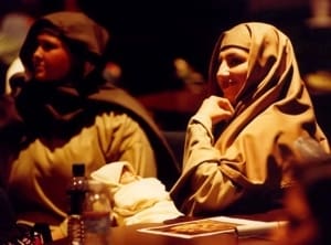 A woman, dressed in Bible costume, resting during a rehearsal.
