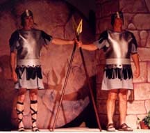 Two Roman soldiers guard the sealed tomb just before Jesus resurrects from the dead as portrayed during the free Christian Easter Pageant play script.