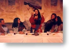 Jesus breaks the bread at the Last Supper.