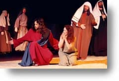 Jesus and the woman caught in adultery with religious leaders around them.