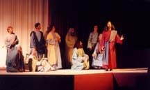 Jesus says Farewell to His disciples at stage edge.