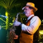 Keith Ward playing his saxophone in an outside venue.